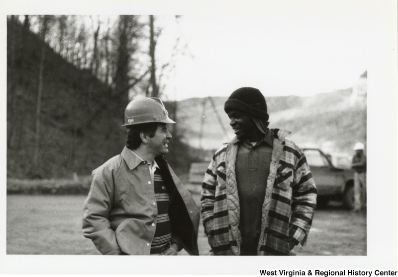 Congressman Nick Rahall, II (left) speaking to an unidentified man at the Hobet Coal Mine.