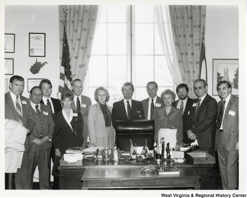 Congressman Nick Rahall, II (center behind desk chair) with an unidentified group of people from the West Virginia-based broadcasters.