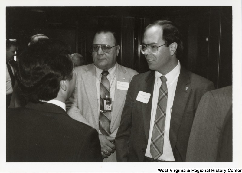 Congressman Nick Rahall II (left, back turned to camera), an unknown man with the first name Bill (middle), and Congressman Harley O. Staggers, Jr. at an event.