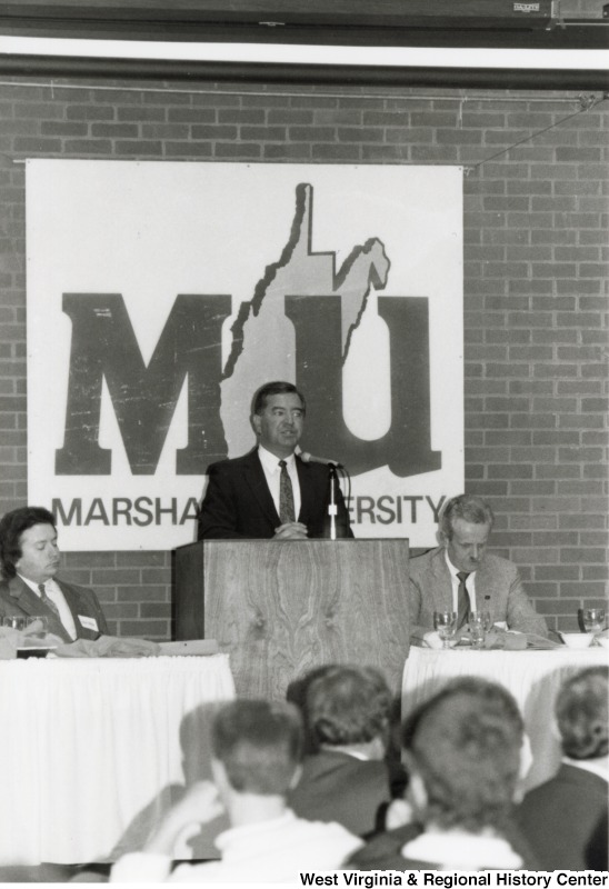 Congressman Nick Rahall, II (center) speaking at Marshall University.