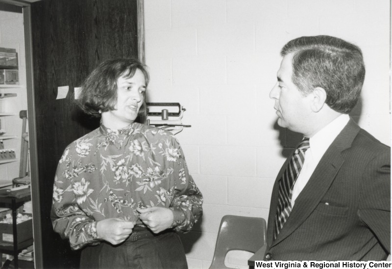 Congressman Nick Rahall, II (left) speaking to an unidentified woman.