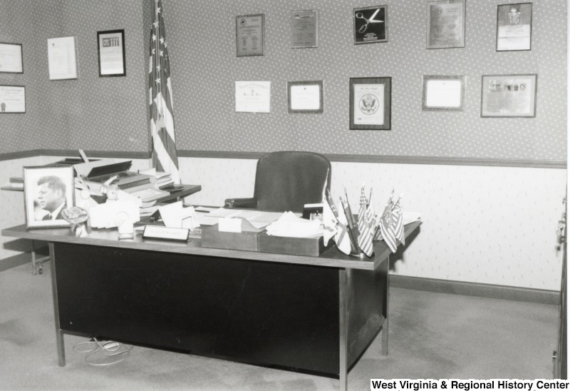 An office with a photograph of President John F. Kennedy on the desk.
