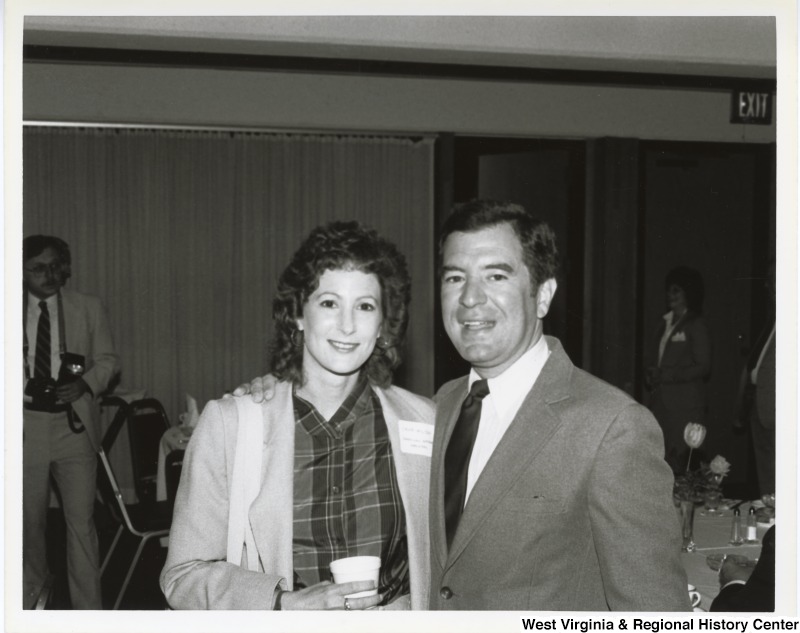Representative Nick J. Rahall (D-W.Va.) poses for a picture with an unidentified woman at a dinner.