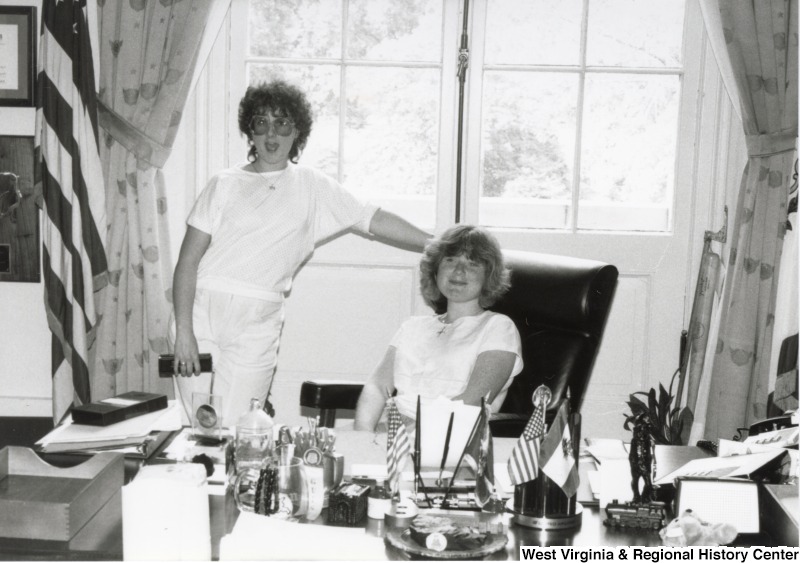 Two unidentified young women in an office space.