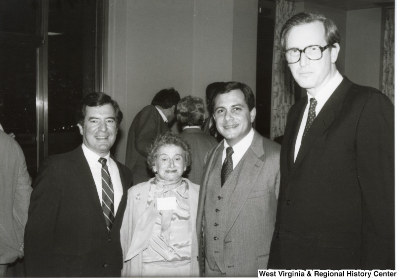 L-R: Representative Nick J. Rahall (D-W.Va.), unidentified woman, unidentified man, Senator John D. Rockefeller IV (D-W.Va.)These four are posing for an image together at an event.