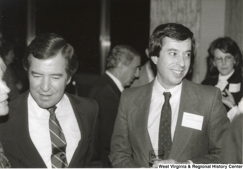 Representative Nick J. Rahall (D-W.Va.) is pictured beside Gary Nordlinger while talking to a people at an event.