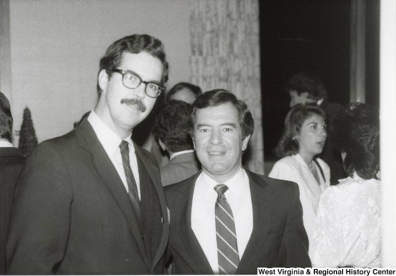 Representative Nick J. Rahall (D-W.Va.) stands to the right of an unidentified man.
