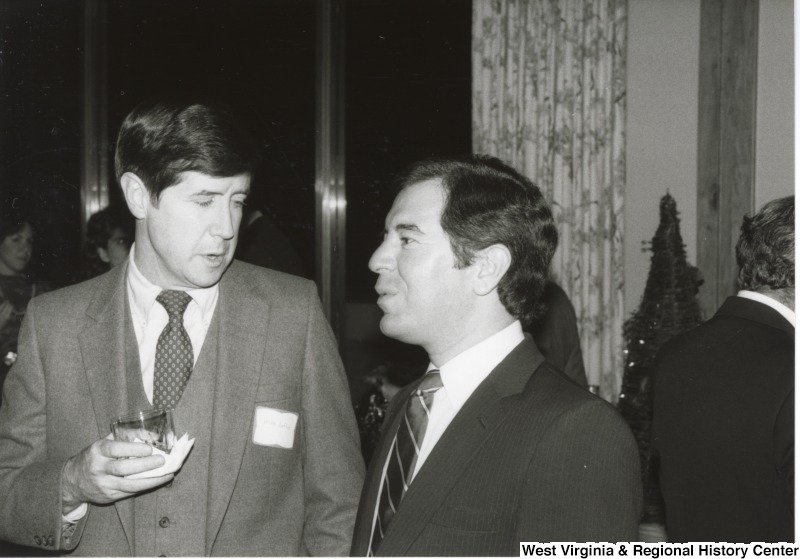 On the right, Representative Nick J. Rahall (D-W.Va.) speaks with Mike Loftus at an event.