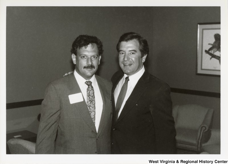 Representative Nick J. Rahall (D-W.Va.) stands to the right of an unidentified man from the American Federation of Government Employees (AFGE) and smiles for a picture.