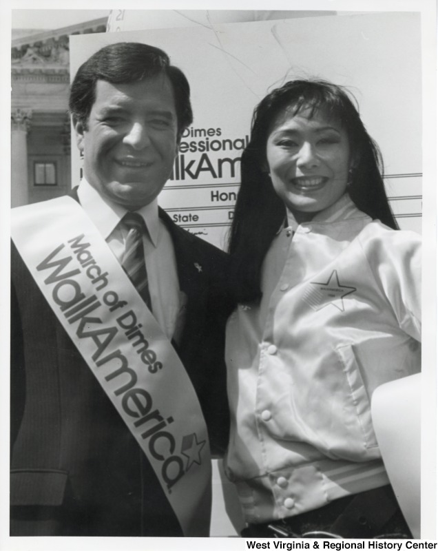 On the right, Representative Nick J. Rahall (D-W.Va.) stands with an unidentified woman at a March of Dimes Walk America event.