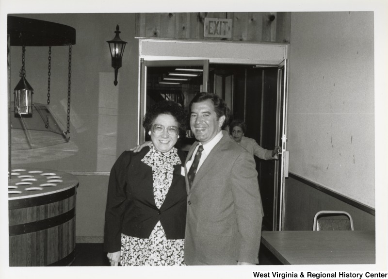 On the right, Representative Nick J. Rahall (D-W.Va.) smiles for a photograph with a women potentially identified at Ellen Jack at an event.