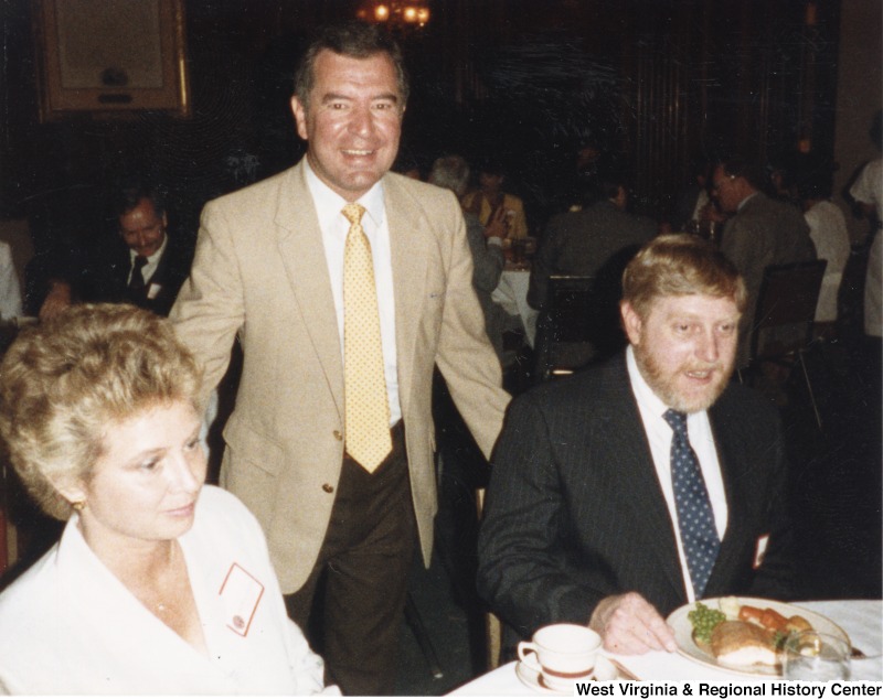 Representative Nick J. Rahall (D-W.Va.)  between an unidentified man and woman at a dinner for Davis and Elkins College donors.