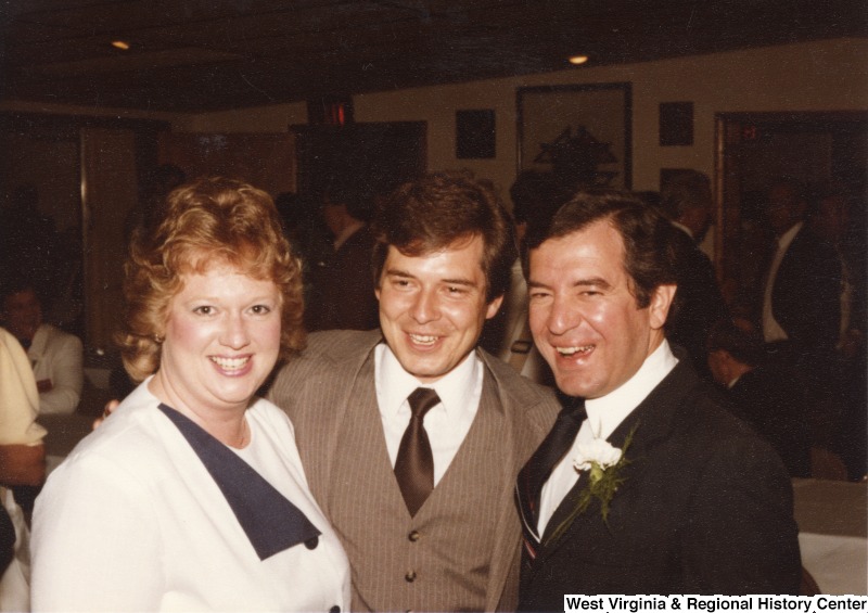 On the far right, Representative Nick J. Rahall (D-W.Va.) smiles for a photograph with an unidentified man and woman at an event.