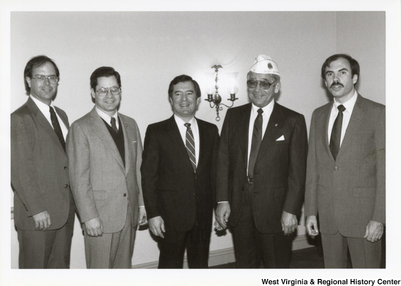 Congressman Nick J. Rahall (D-W.V.), center, with Congressman Bob Wise (D-W.V.), first on the right, with three unidentified men. The man to the left of Congressman Wise wears an American Legion cap.