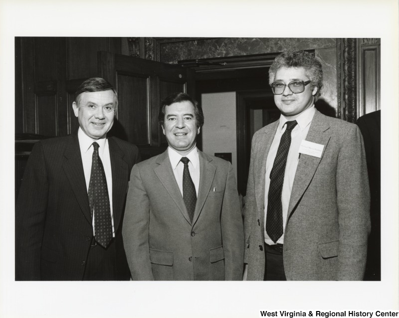 Representative NIck J. Rahall (D-W.Va.) stands between two unidentified men at the Federal Coal Export Commission.
