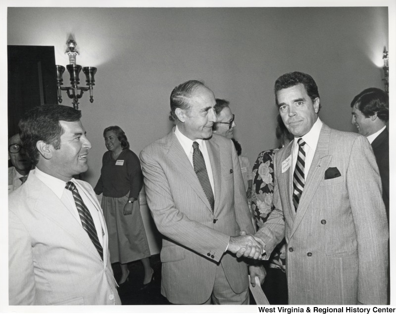 L-R: Representative Nick J. Rahall (D-W.Va.), Henry Mancini, Representative Doug Applegate (D-Oh.).Representative Applegate shakes hands with Henry Mancini at an event.
