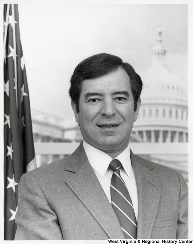 Representative Nick J. Rahall (D-W.Va.) is seen in front of an American flag and the Capitol building.