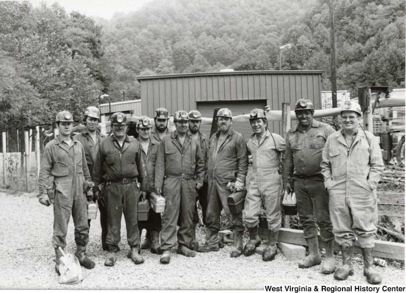 Congressman Nick Rahall dress in coal mining uniform at Old Ben Coal Mine with ten unidentified coal miners
