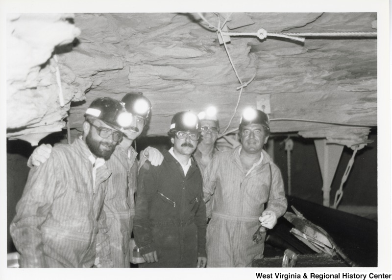Congressman Nick Rahall dressed in a coal miner uniform inside of Old Ben Coal Mine with four unidentified coal miners.