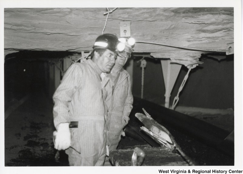 Congressman Nick Rahall dress in coal miner uniform inside of Old Ben Coal Mine with one unidentified coal miner