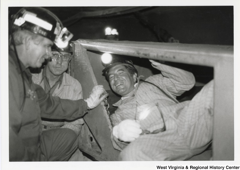 Congressman Nick Rahall inside of mine car at Old Ben Coal  Mine with two unidentified coal miners.