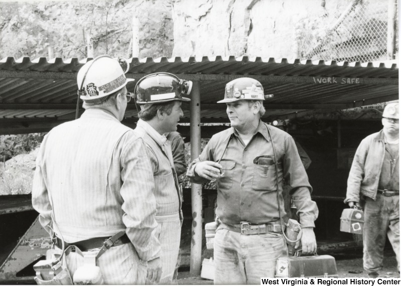 Congressman Nick Rahall dressed in a coal miner uniform at Old Ben Coal Mine with two unidentified coal miners