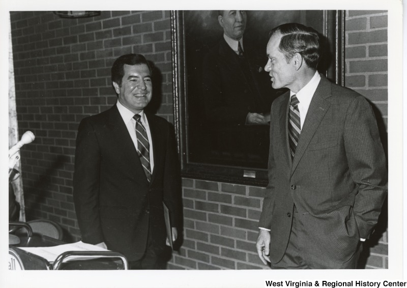 Congressman Nick Rahall talking with an unidentified man during an official visit at Marshall University.