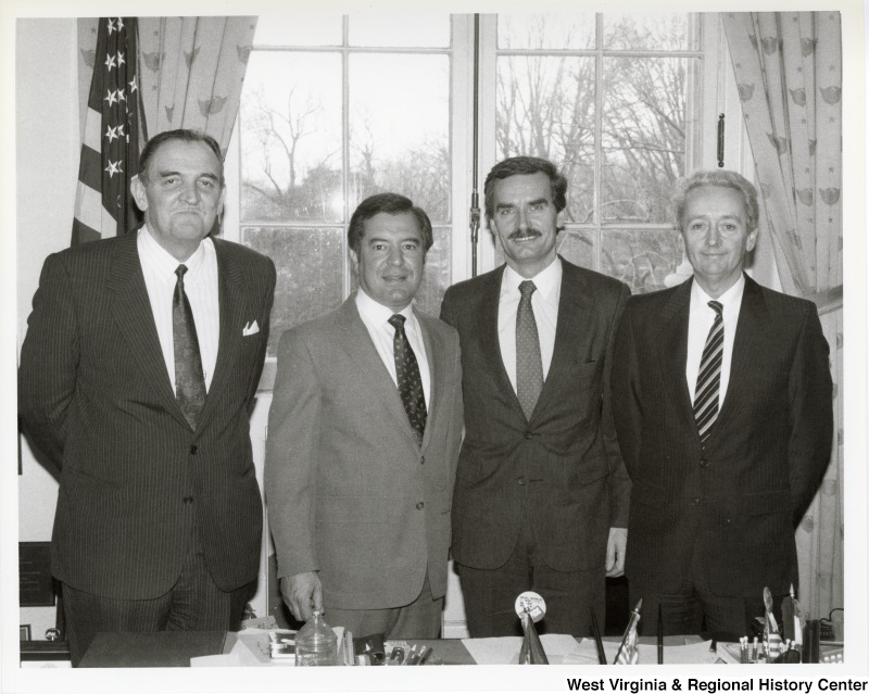 Congressman Nick Rahall with Anthony Culley-Foster, current CEO of World Affairs Council and Founder of CFCO International, and two unidentified men in an office.