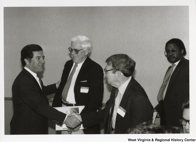 Congressman Nick Rahall speaking with two unidentified men at an Economic Development Seminar in Bluefield, West Virginia.