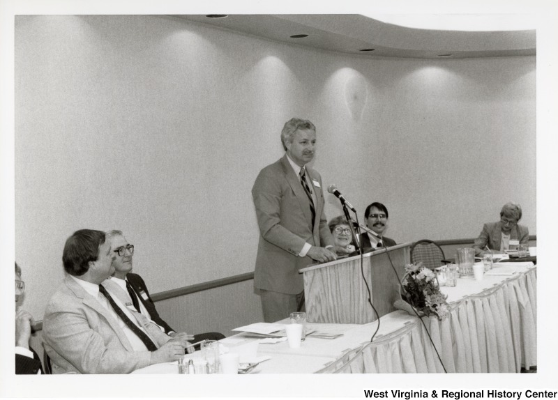 An unidentified man speaking at an Economic Development Seminar attended by Congressman Nick Rahall in Bluefield, West Virginia.