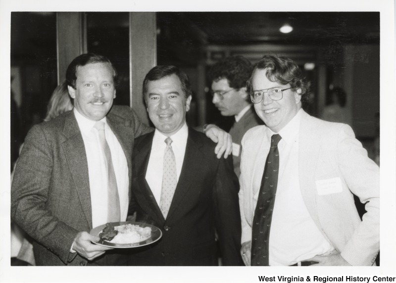 Congressman Nick Rahall with two unidentified men at a breakfast.