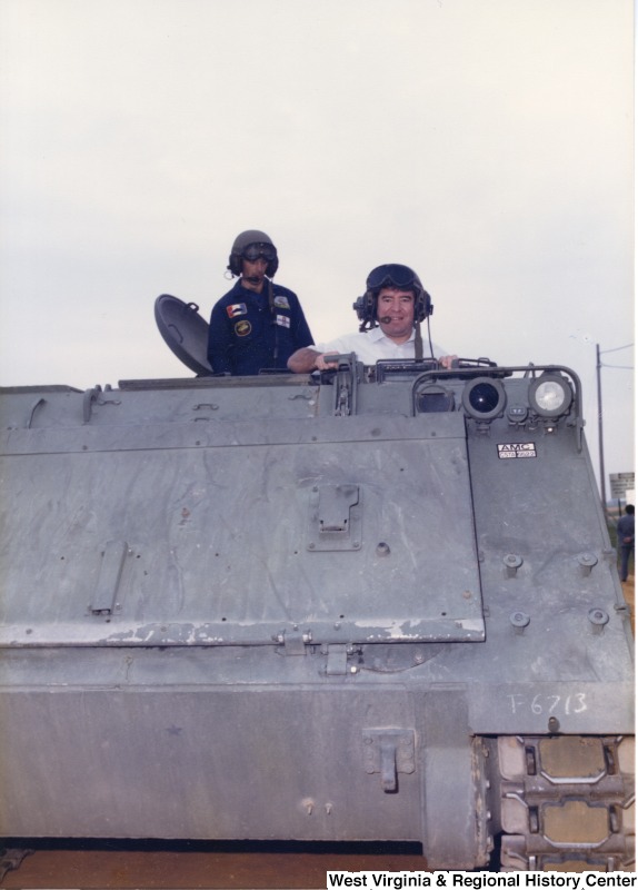 Congressman Nick Rahall with an unidentified United States Army service member in a tank at Aberdeen Proving Ground.