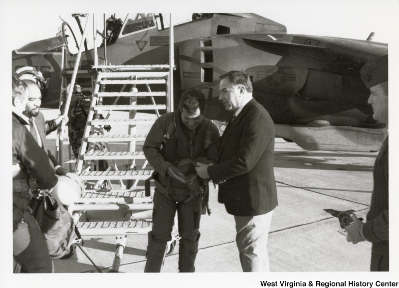Congressman Nick Rahall with an unidentified man in front of a harrier jet in Quantico, Virginia.