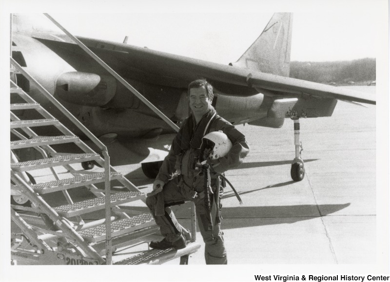 Congressman Nick Rahall dressed in a flight suit in front of a harrier jet at Marine Corps Base Quantico, Virginia.