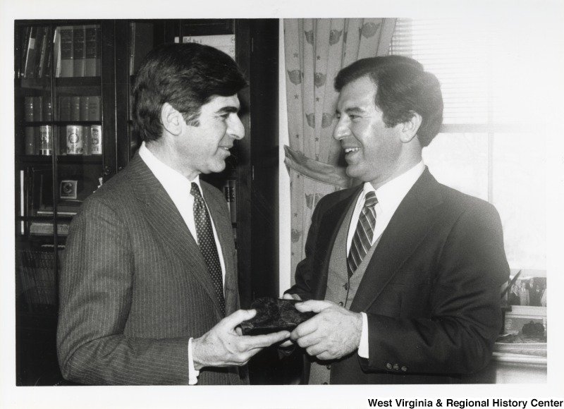 Congressman Nick Rahall talking to Massachusetts Governor and Democratic candidate for president. The two appear to be exchanging a stone.