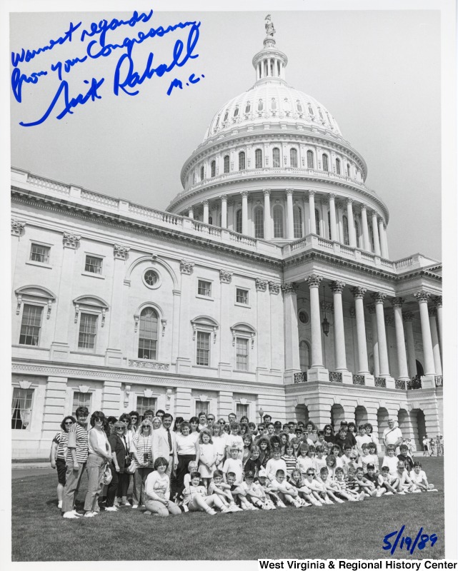 Congressman Nick Rahall with Ona Elementary School (Ona, WV) students in front of the United States Capitol building. Photograph is signed "Warm regards from your Congressman. Nick Rahall. M.C."