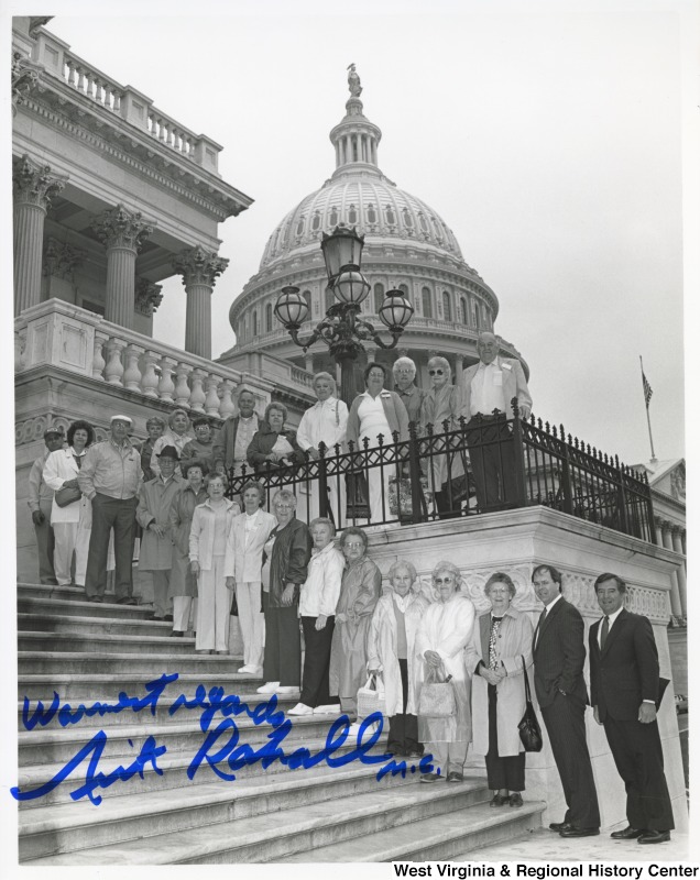 Congressman Nick Rahall with unidentified Fayette County Senior citizens in front of the United States Capitol building. Photograph is signed "Warm Regards, Nick Rahall. M.C."