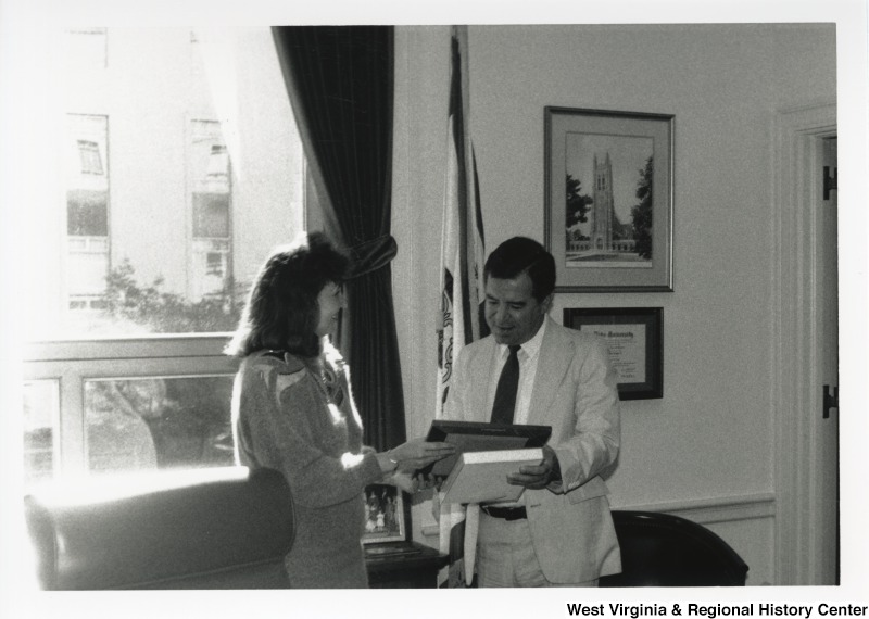Congressman Nick Rahall receiving a plaque from an unidentified Friends of Home Economics representative.
