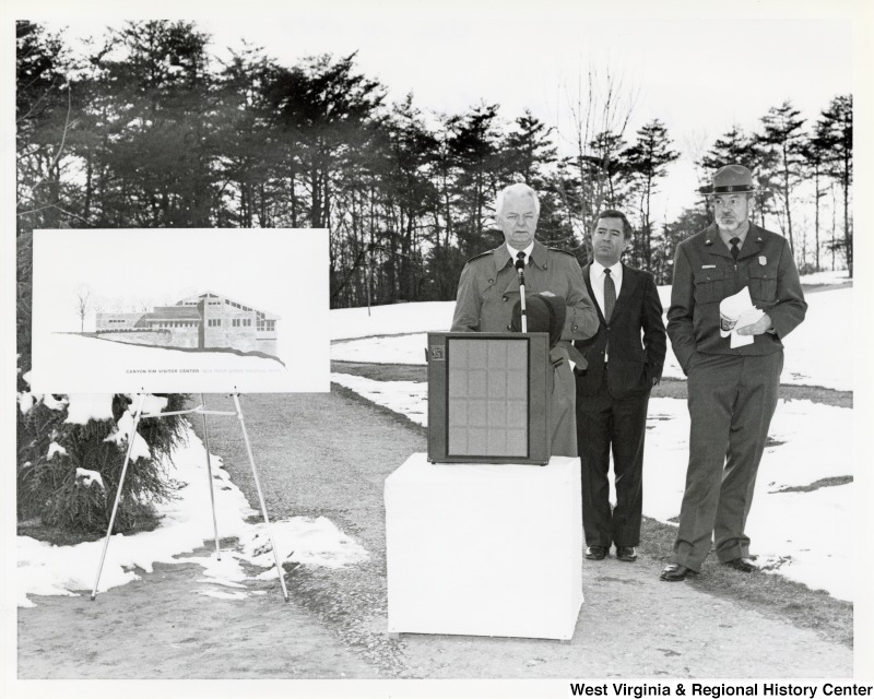 Senator Robert C. Byrd (D-WV) making a speech before the ribbon cutting for New River Gorge Park. Congressman Nick Rahall (D-WV) and United States Park Service Sergeant, Joe Kennedy are seen listening behind him.