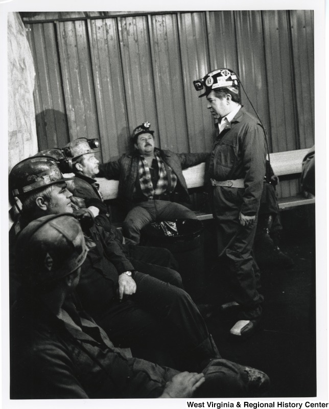 Congressman Nick Rahall (D-WV) speaking with a group of unidentified coal miners at a mine site.
