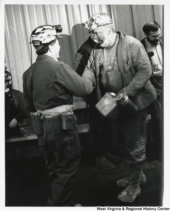 Congressman Nick Rahall (D-WV) shaking hands with an unidentified coal miner.
