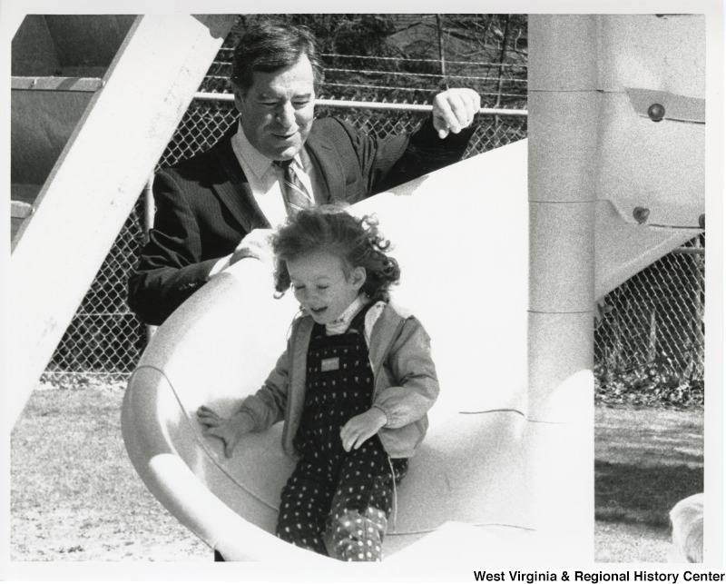 Congressman Nick Rahall (D-WV) with an unidentified girl on a slide.