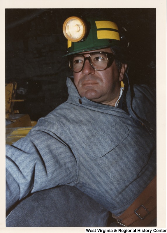 Congressman Nick Rahall (D-WV) dress in a coal miner uniform inside of a mine car.
