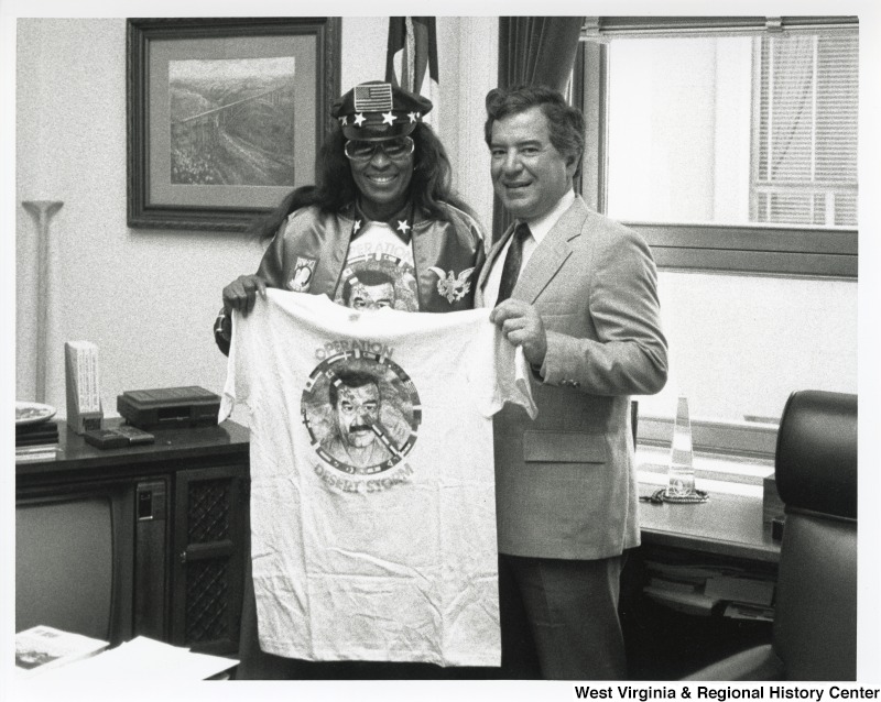 Congressman Nick Rahall (D-WV) holding an anti-Desert Storm t-shirt with Captain Mom at his office.