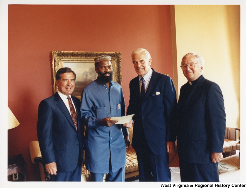 From left to right: Congressman Nick Rahall (D-WV), Imam Siraj Wahaj, an unidentified man, and an unidentified priest.