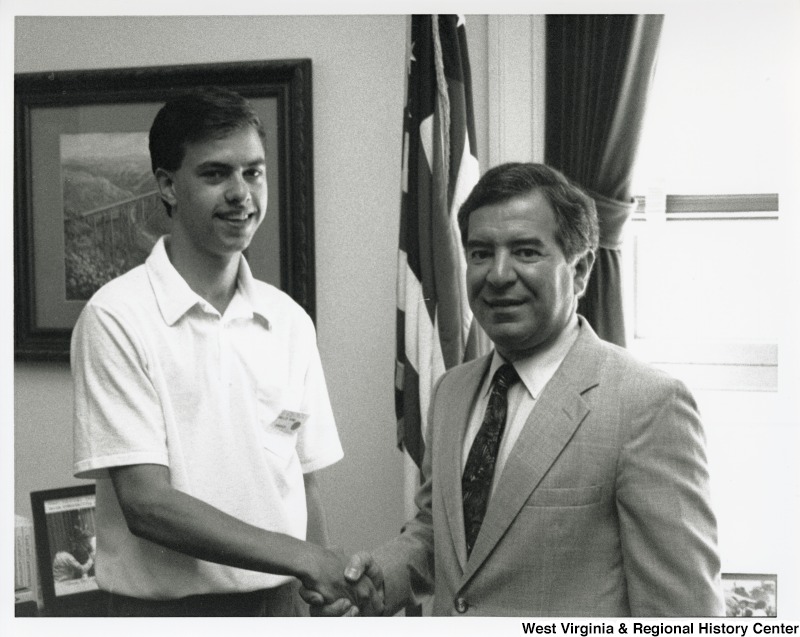 On the right, Representative Nick J. Rahall (D-W.Va.) shakes hands with an unidentified man from the National Young Leader conference.