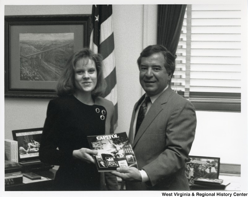 On the right, Representative Nick J. Rahall (D-W.Va.) smiles for a photograph with an unidentified woman.