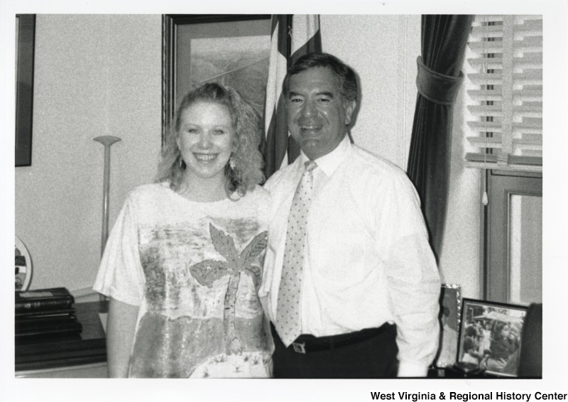 On the right, Representative Nick J. Rahall (D-W.Va.) smiles for a photograph with Page April Neveau in an office.
