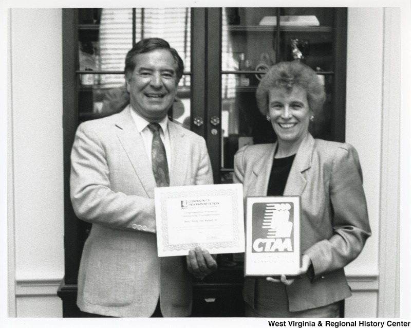 Representative Nick J. Rahall (D-W.Va.) poses for a photograph handing the Community Transportation Association of America (CTAA) Award to Vickie Schaffer.