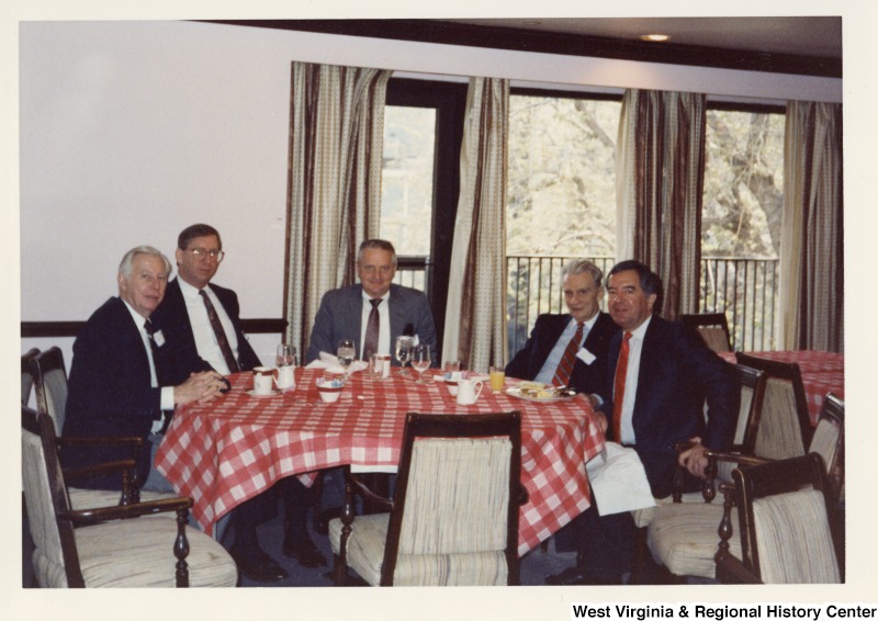On the far right, Representative Nick J. Rahall (D-W.Va.) eats breakfast with four unidentified men of the Democratic Club.